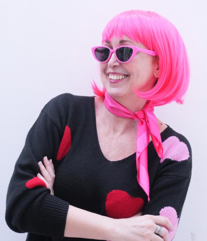 Federica wearing a bright pink bob wig, the symbol of The Pink Bob breast cancer awareness initiative.