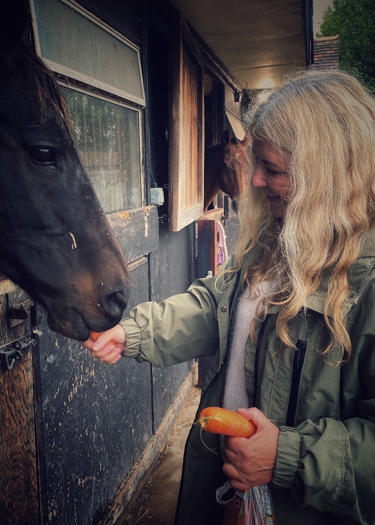 Sacha feeding her horse black beauty