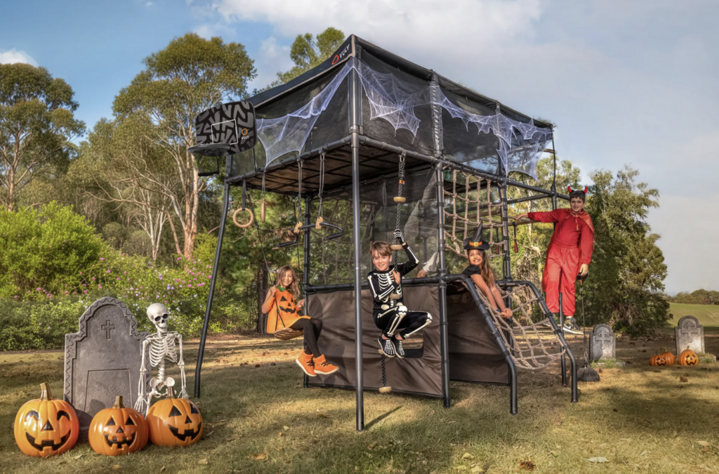 treehouse playset with halloween decorations and kids having fun